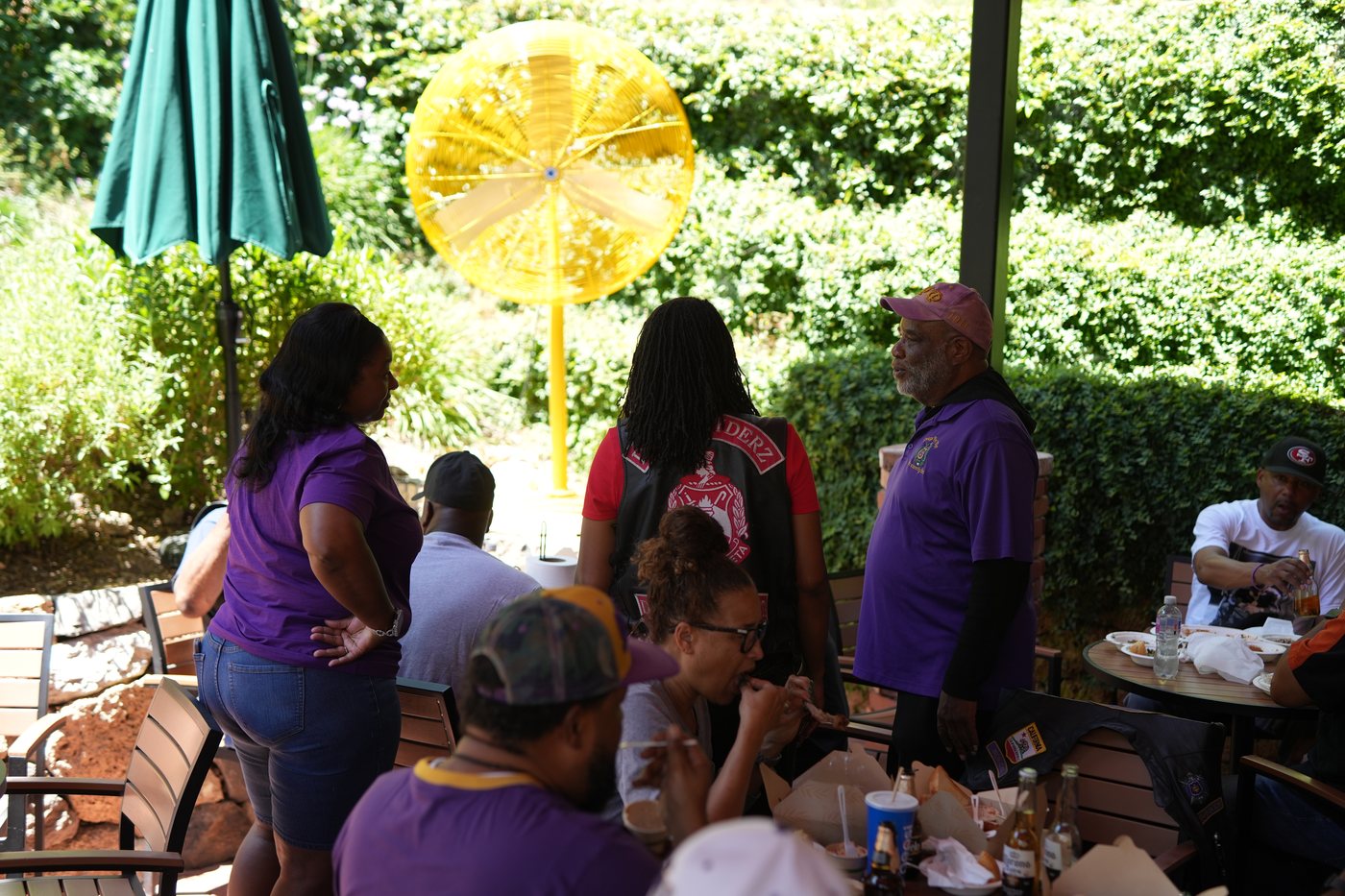 Riders in Delta Ryderz vests and Omega Psi Phi colors gathered for barbecue on the Busters of Calistoga patio, 2025 Freedom Ride